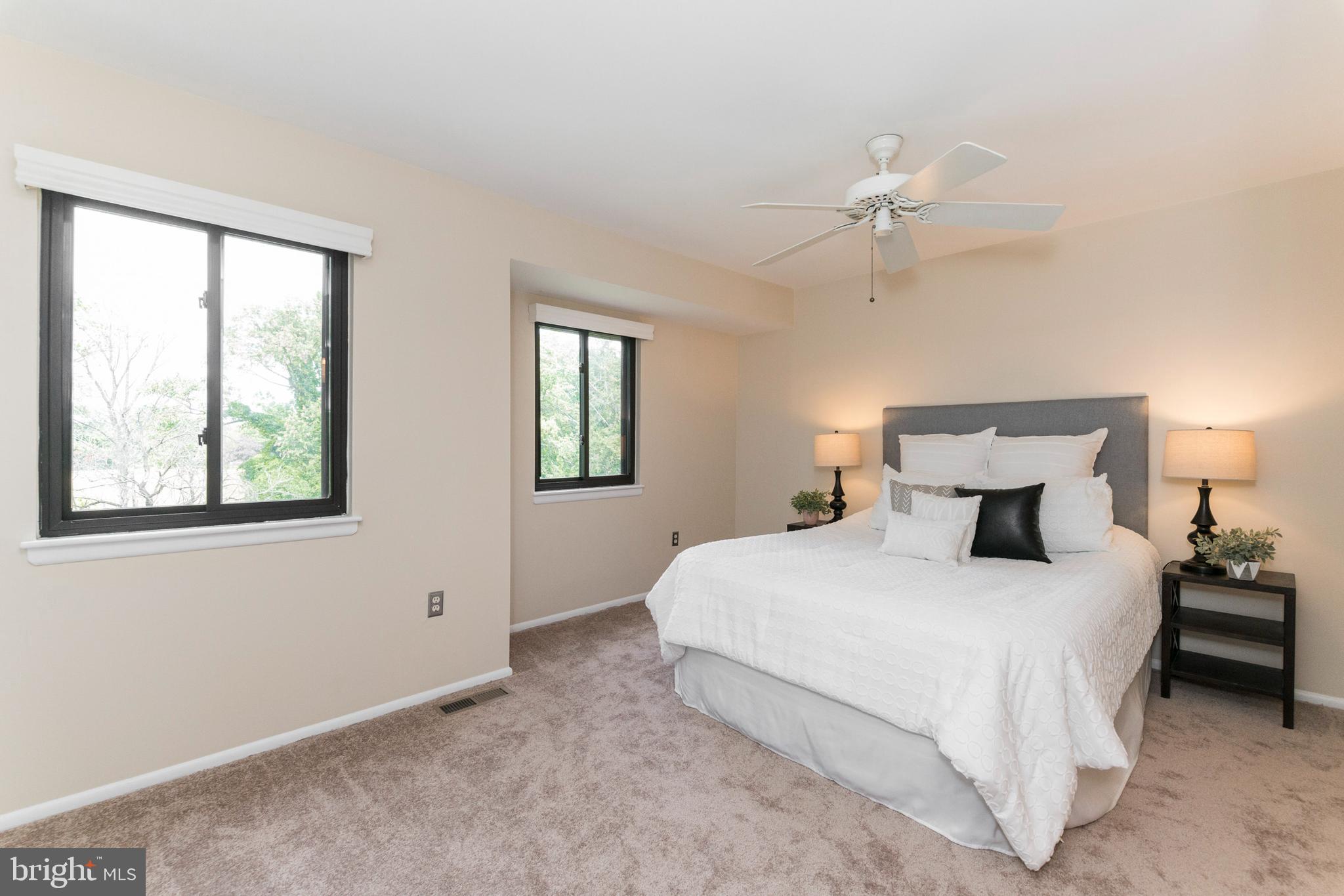 18 Stone Ridge Court, Unit 23 Baltimore, MD 21239 - Photo 15 of 19 a bedroom with a large bed and a chandelier