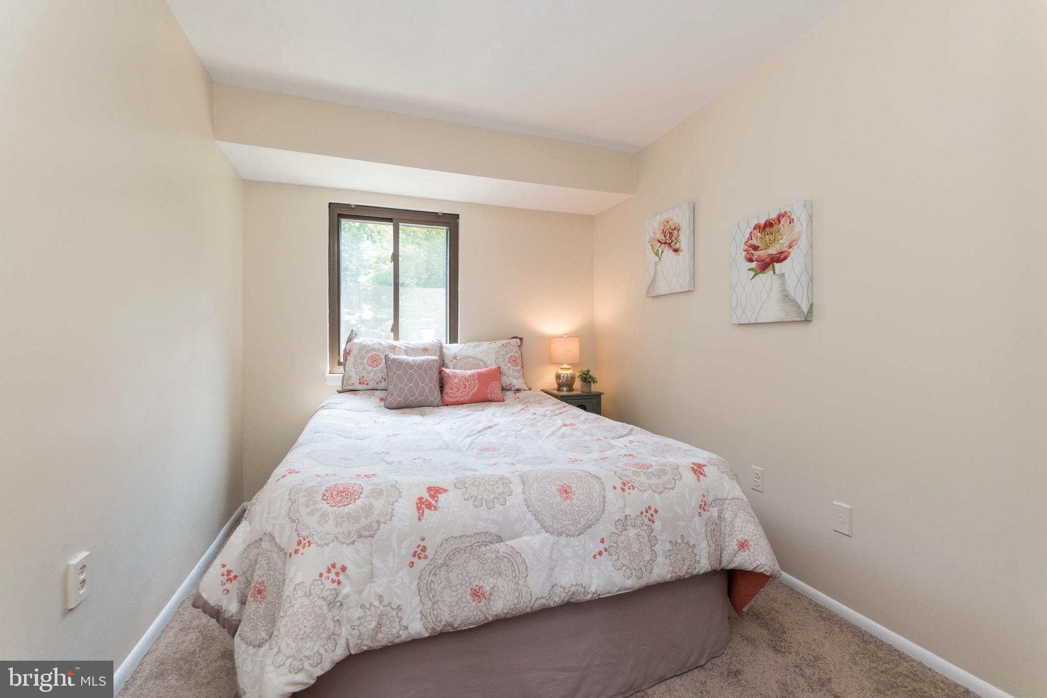18 Stone Ridge Court, Unit 23 Baltimore, MD 21239 - Photo 16 of 19 a bedroom with a bed and a window