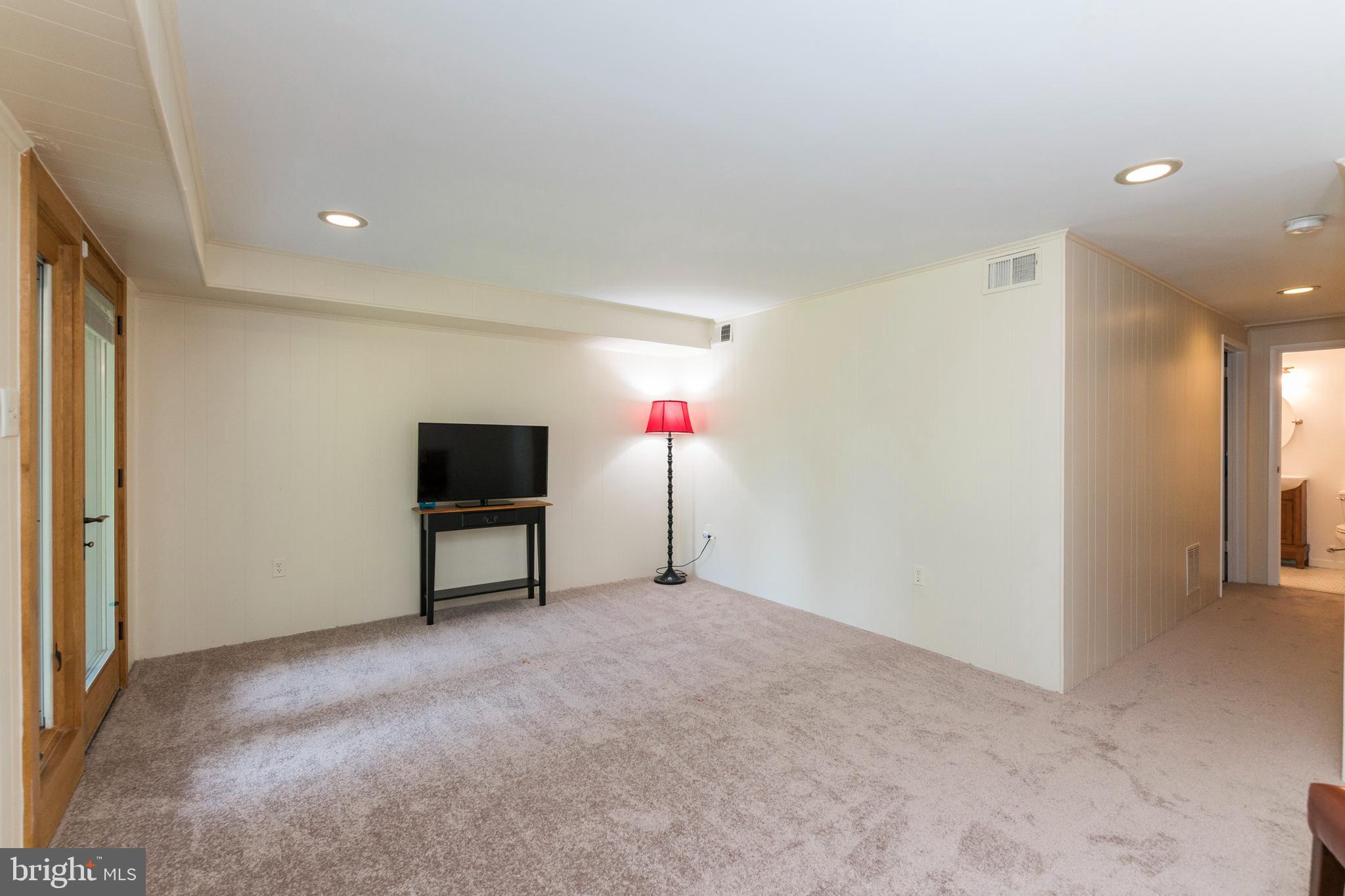 18 Stone Ridge Court, Unit 23 Baltimore, MD 21239 - Photo 17 of 19 a living room with furniture and a flat screen tv