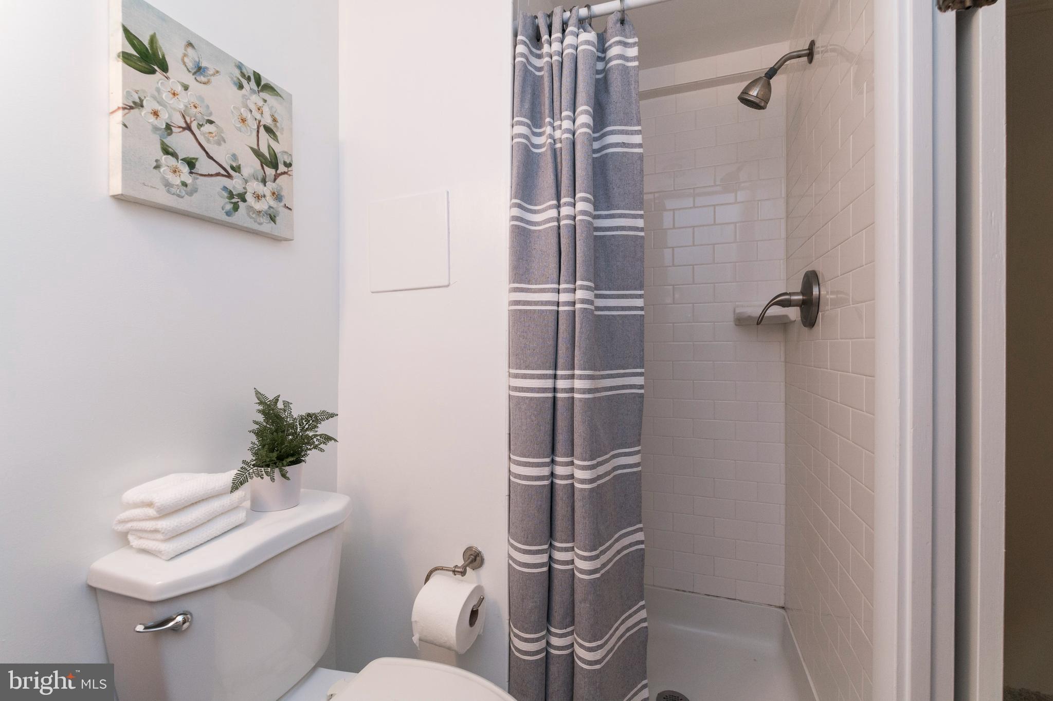 18 Stone Ridge Court, Unit 23 Baltimore, MD 21239 - Photo 19 of 19 a bathroom with a toilet and a shower