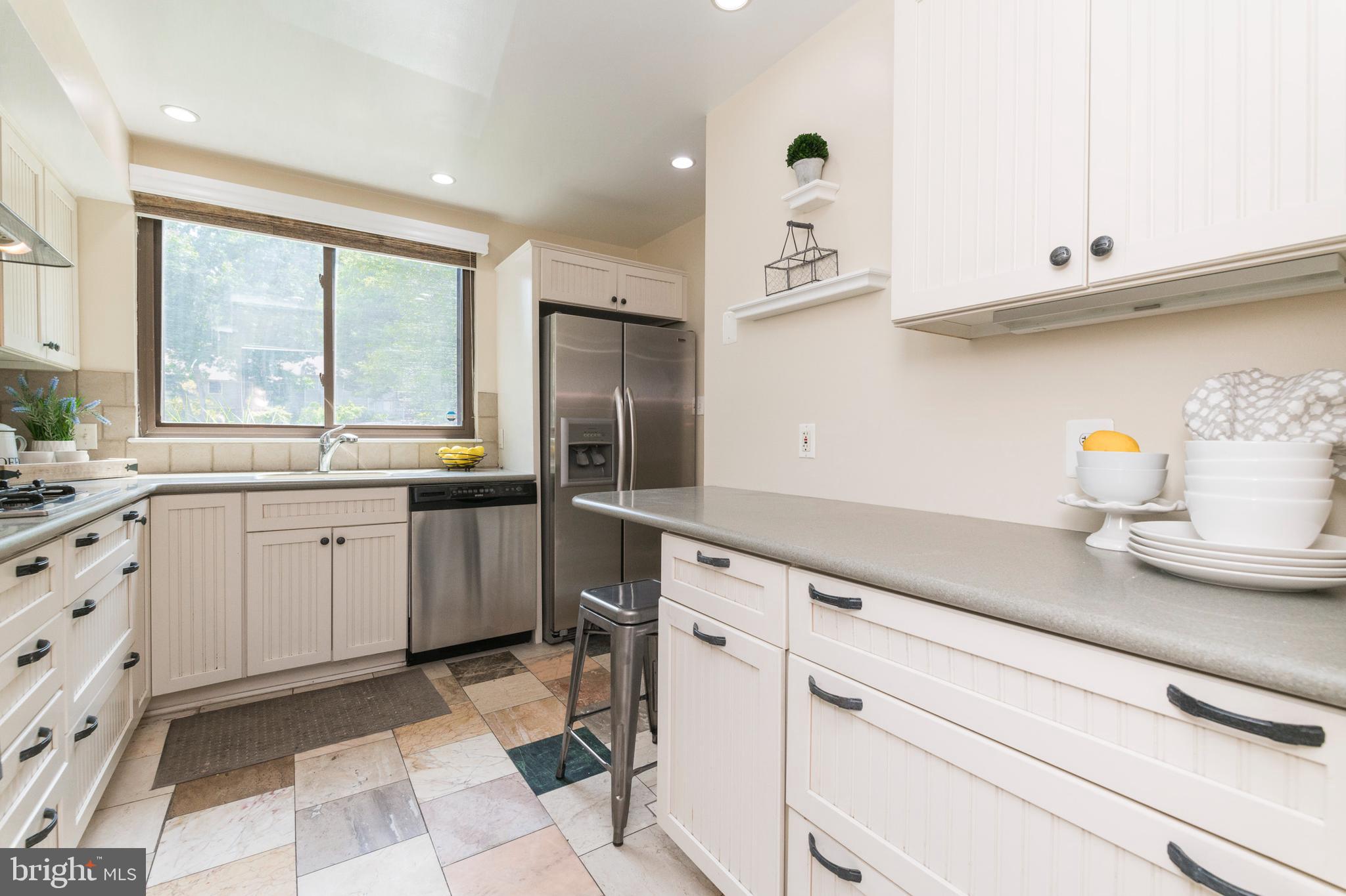18 Stone Ridge Court, Unit 23 Baltimore, MD 21239 - Photo 3 of 19 a kitchen with a sink window and cabinets