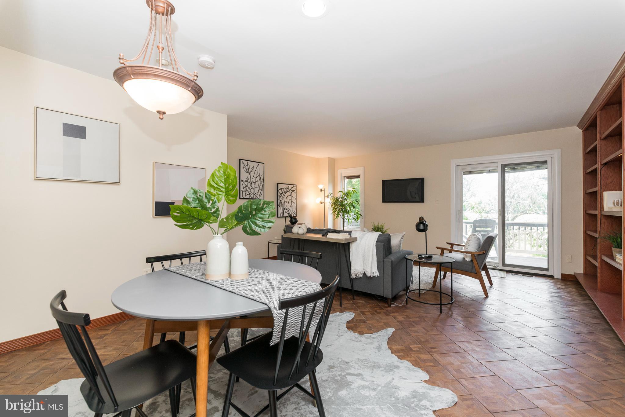 18 Stone Ridge Court, Unit 23 Baltimore, MD 21239 - Photo 5 of 19 a view of a dining room with furniture and a potted plant