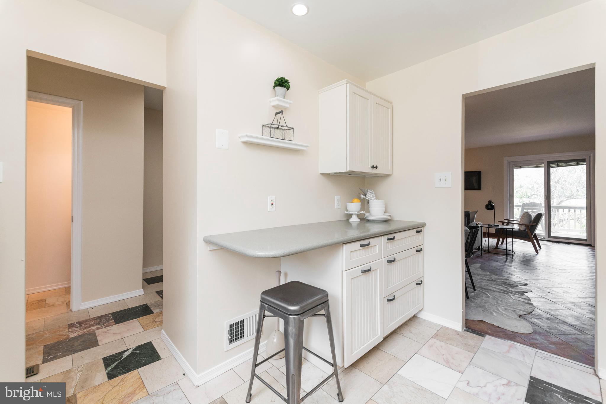 18 Stone Ridge Court, Unit 23 Baltimore, MD 21239 - Photo 8 of 19 a spacious bathroom with a granite countertop sink a mirror and a bathtub