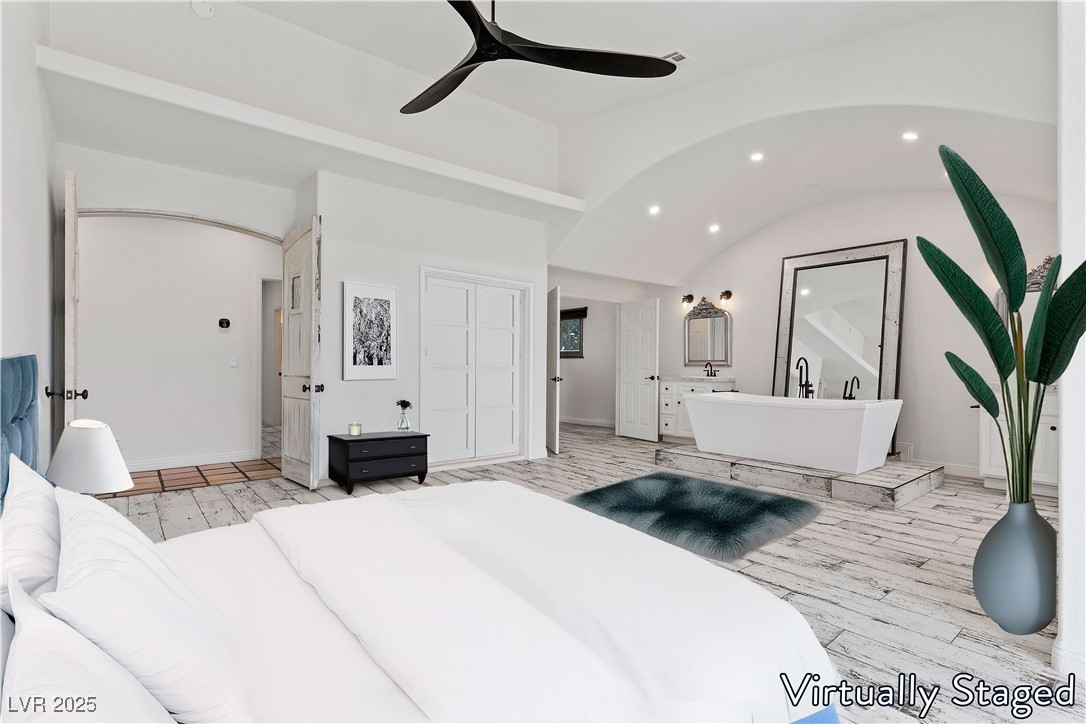 5555 West Desert Inn Road Las Vegas, NV 89146 - Photo 15 of 50 Virtually Staged- The primary suite has been customized, offering a soaking tub, dual vanities & separate shower.
