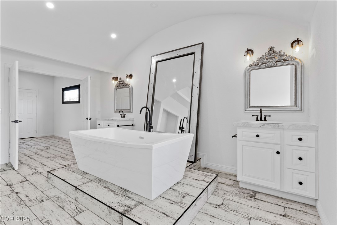 5555 West Desert Inn Road Las Vegas, NV 89146 - Photo 17 of 50 The exceptional primary bathroom features a dual vanity and a generous-sized mirror that enhances the elegance of the space.