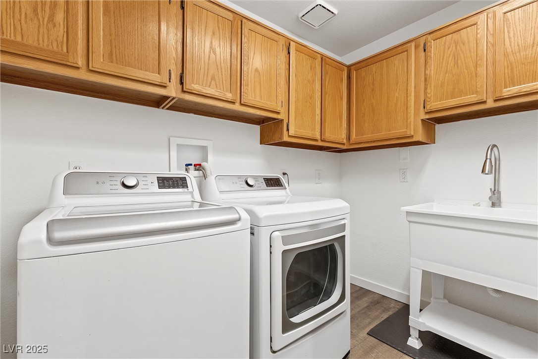 5555 West Desert Inn Road Las Vegas, NV 89146 - Photo 27 of 50 Separate laundry room has convenient overhead cabinets and a sink!