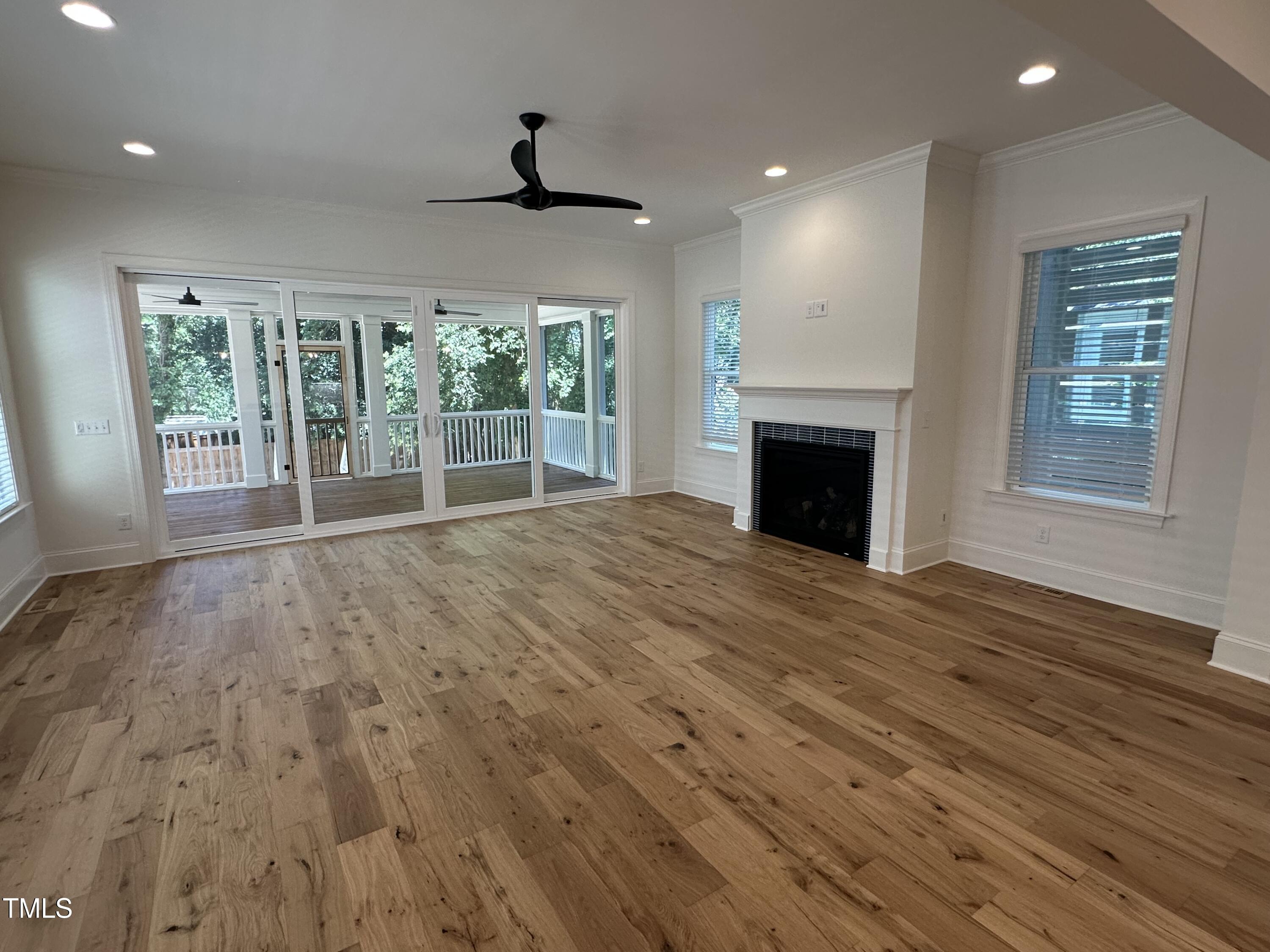 3302 Hall Place Raleigh, NC 27607 - Photo 11 of 25 a view of empty room with wooden floor and fireplace