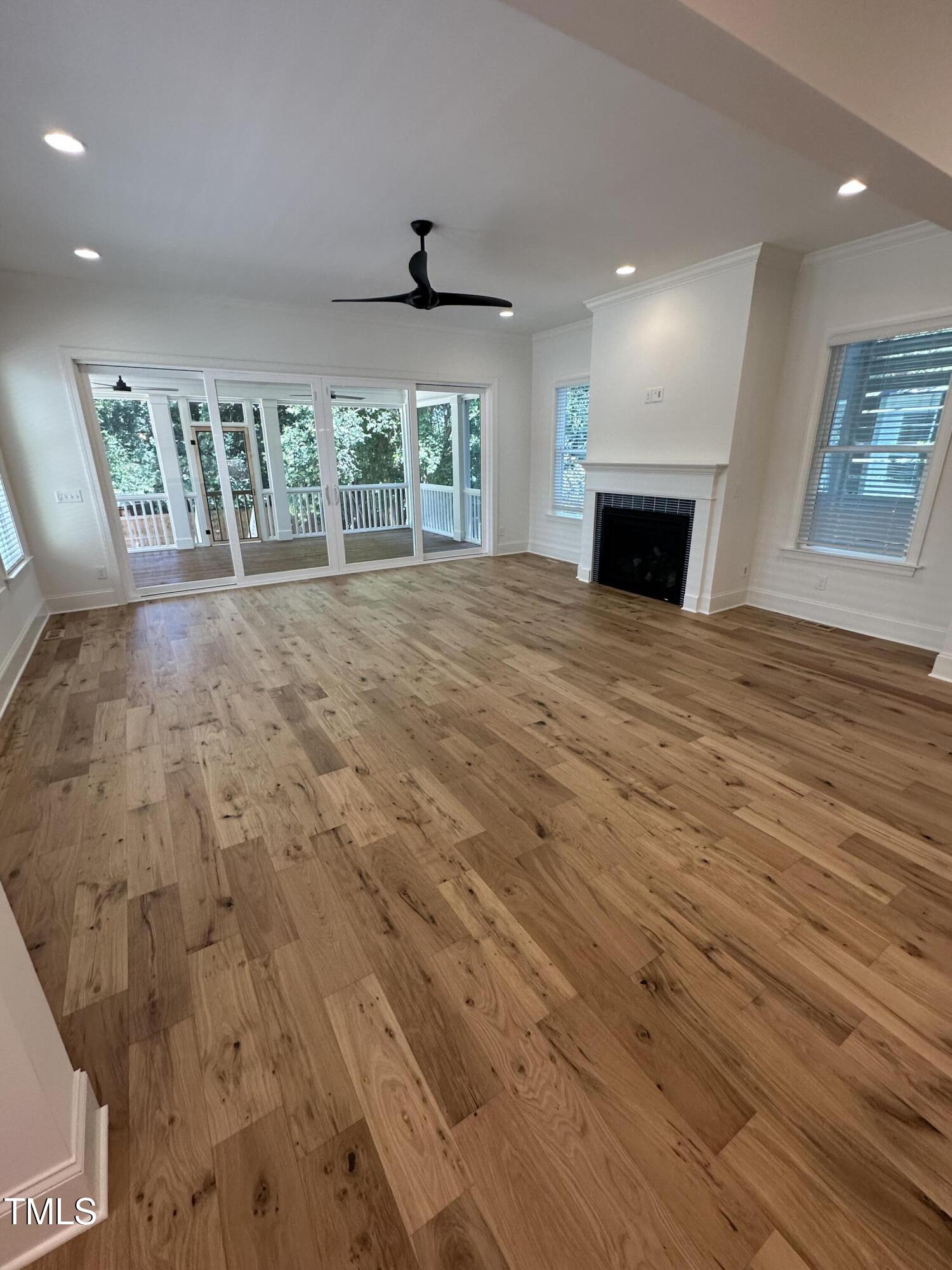 3302 Hall Place Raleigh, NC 27607 - Photo 12 of 25 a view of an empty room with a fireplace and a window