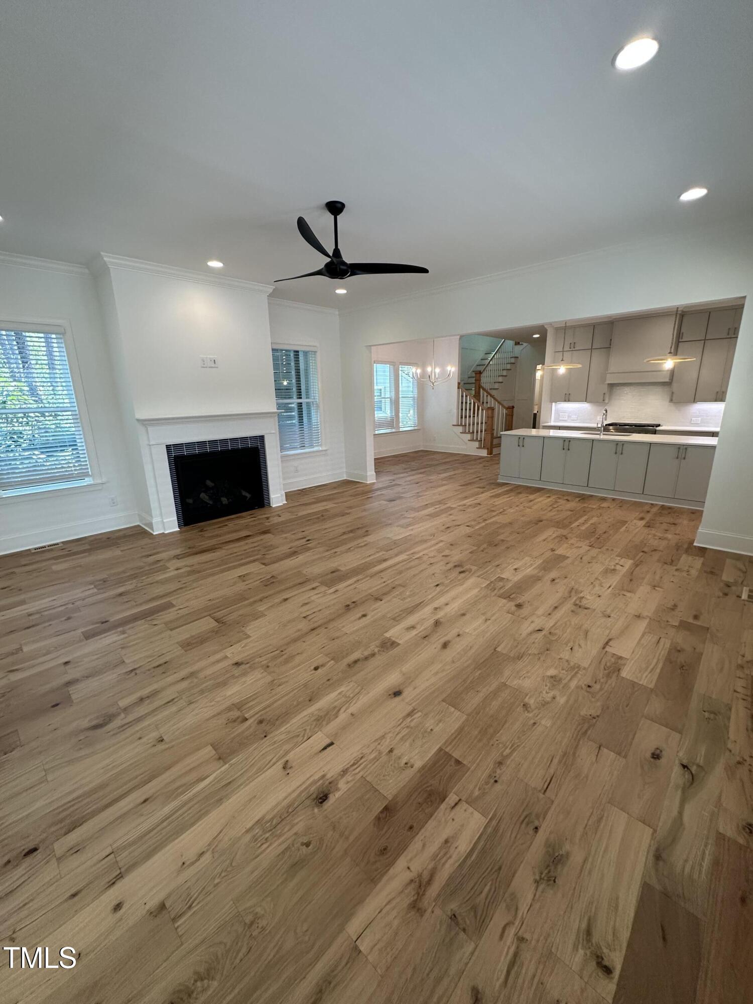 3302 Hall Place Raleigh, NC 27607 - Photo 14 of 25 a view of empty room with wooden floor and fireplace