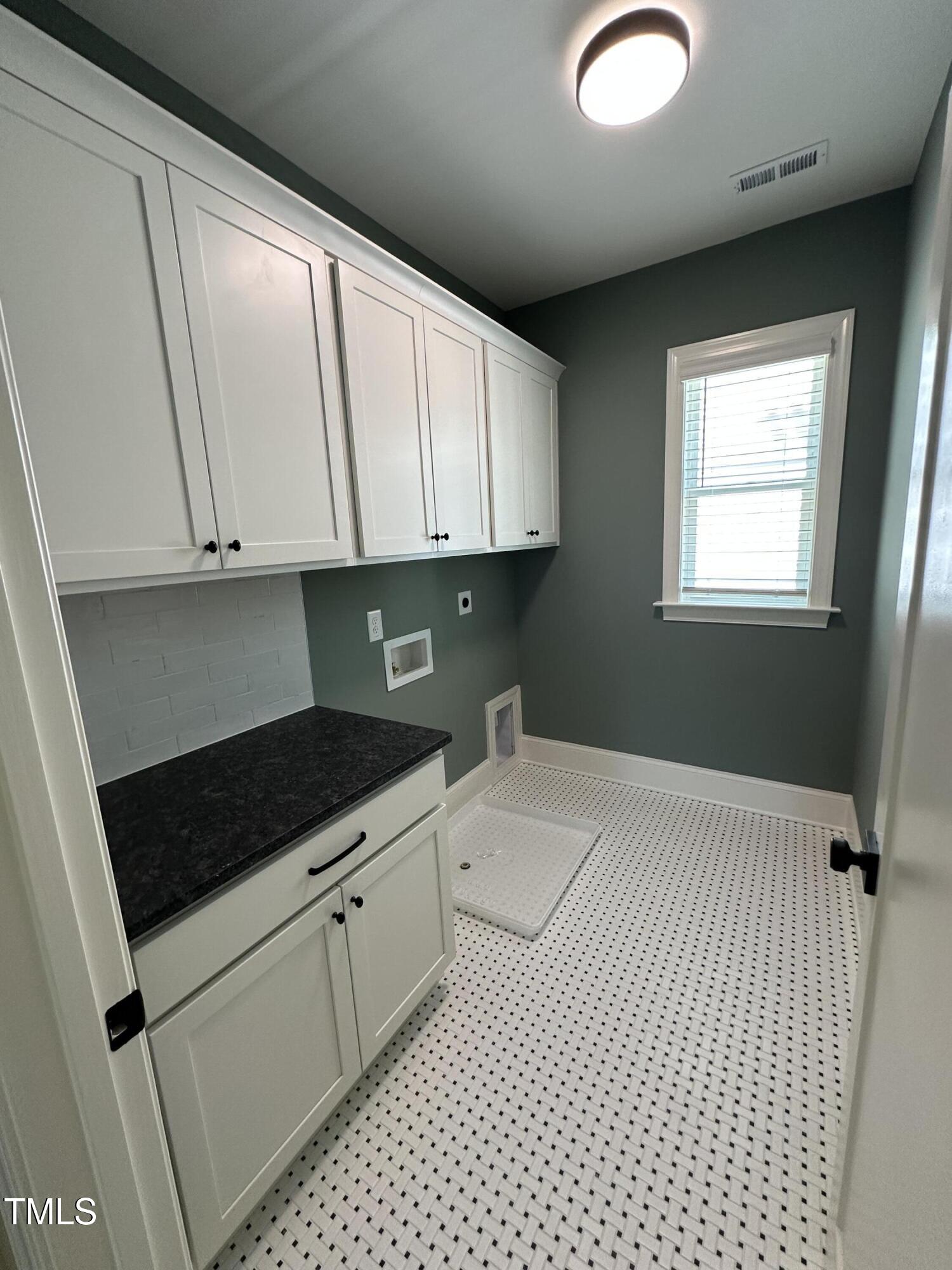 3302 Hall Place Raleigh, NC 27607 - Photo 15 of 25 a kitchen with a sink and cabinets
