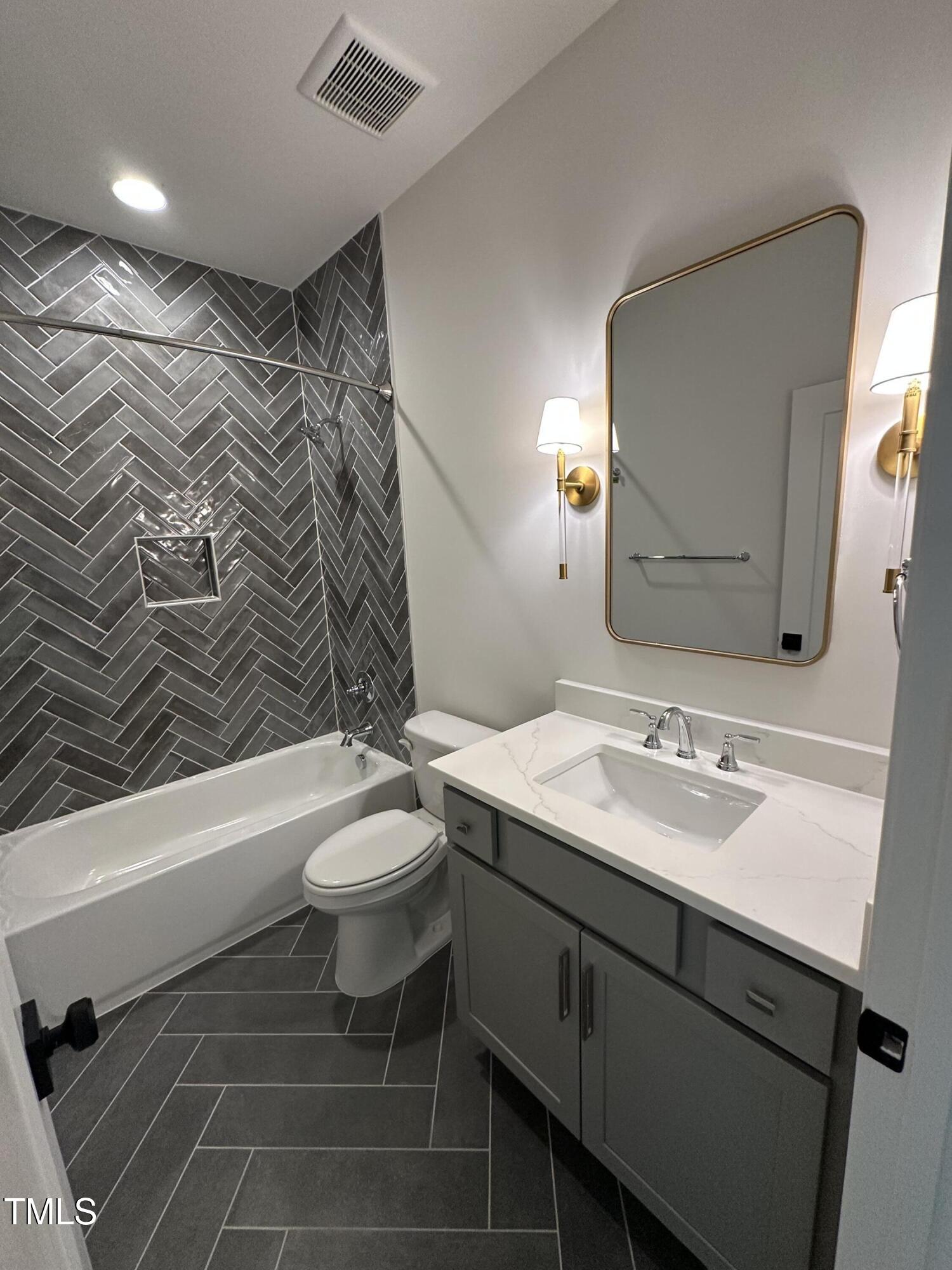 3302 Hall Place Raleigh, NC 27607 - Photo 16 of 25 a bathroom with a sink a toilet and shower