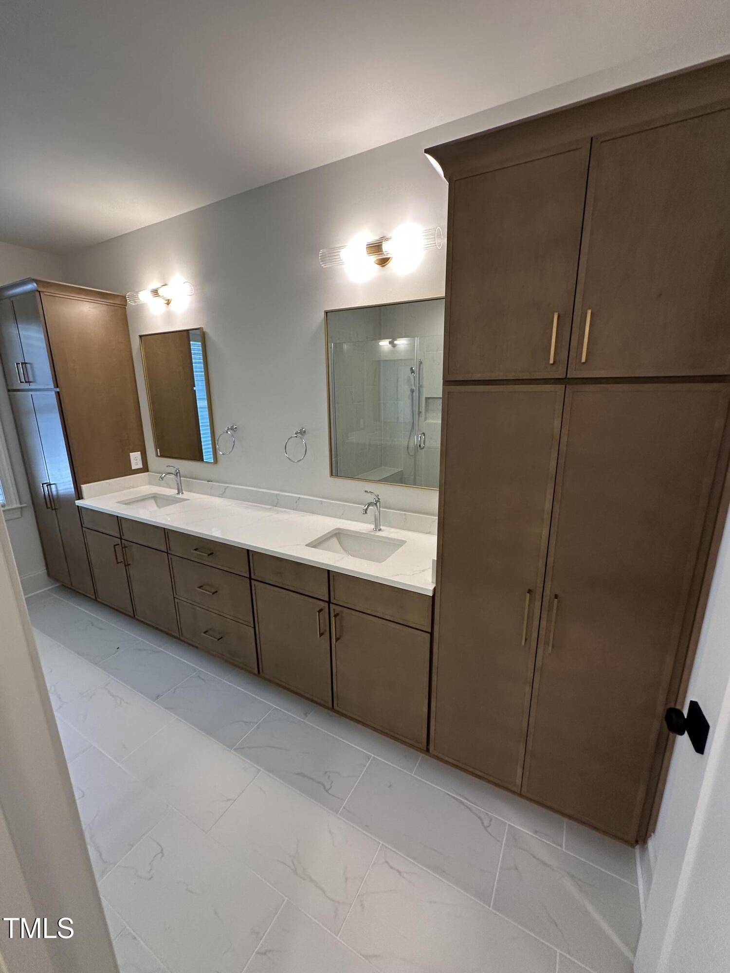 3302 Hall Place Raleigh, NC 27607 - Photo 18 of 25 a bathroom with a double vanity sink and mirror