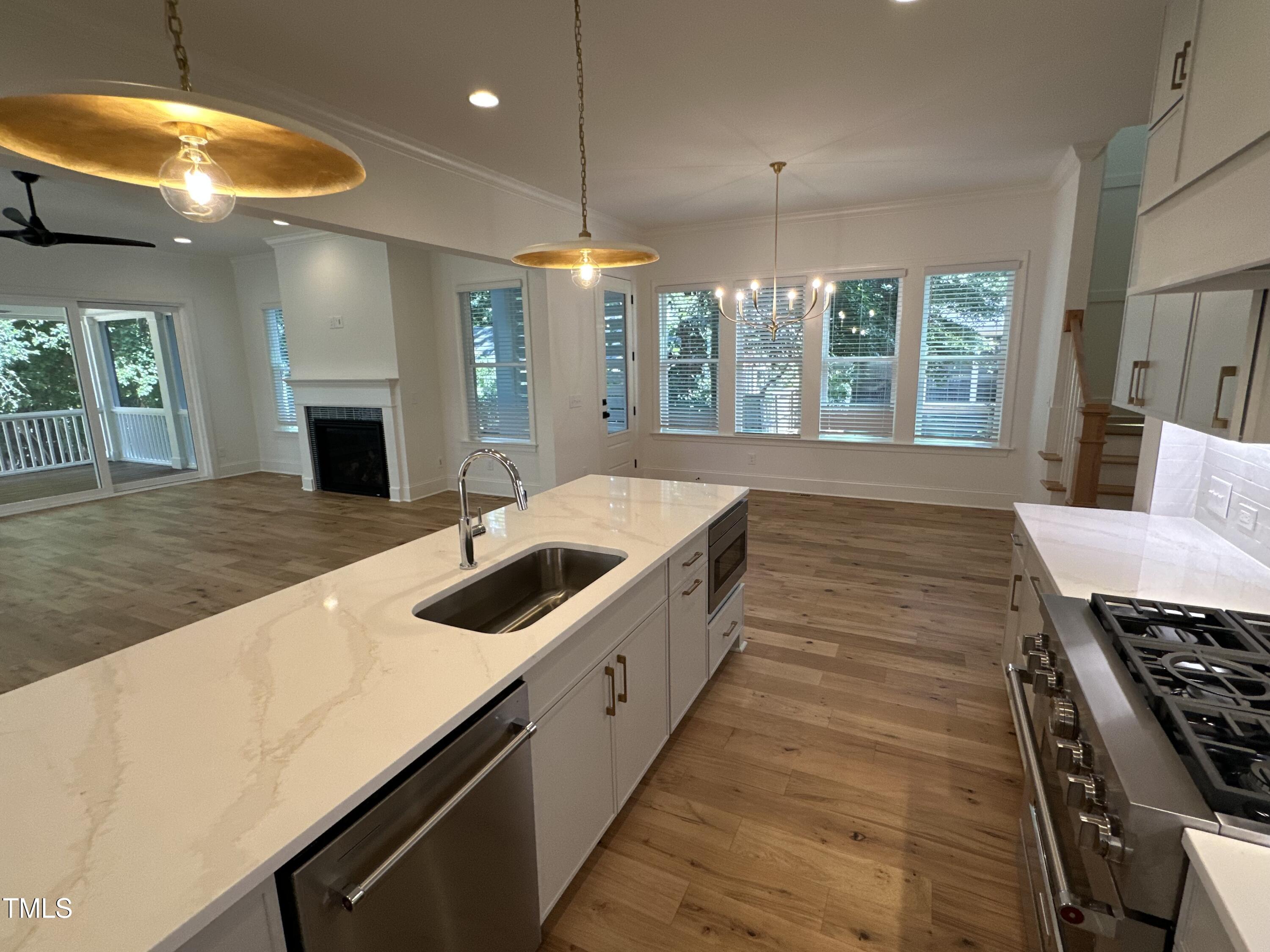 3302 Hall Place Raleigh, NC 27607 - Photo 23 of 25 a large kitchen with kitchen island a large counter space a sink and appliances