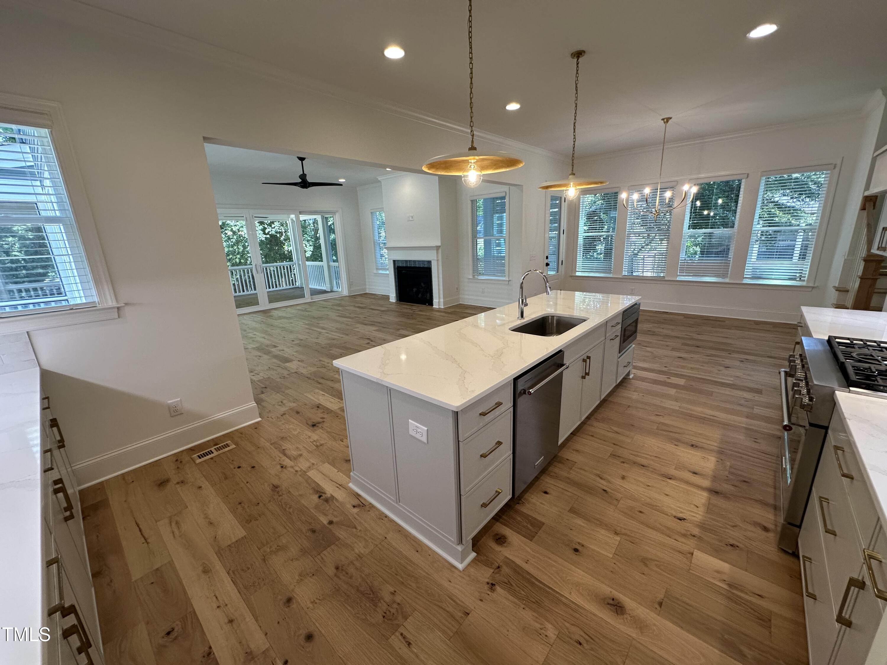 3302 Hall Place Raleigh, NC 27607 - Photo 8 of 25 a kitchen with stainless steel appliances a sink and a large window