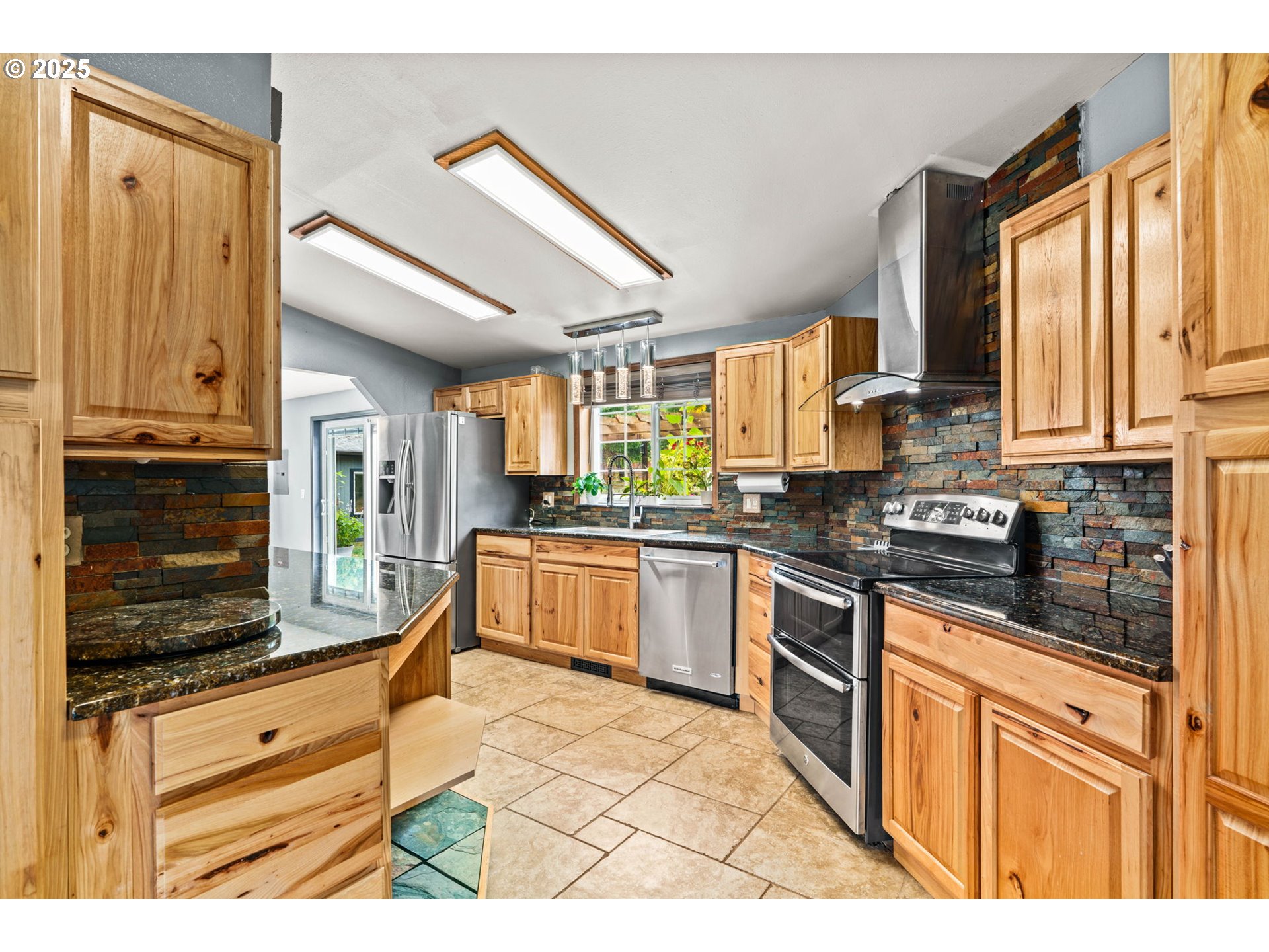 37495 Parsons Creek Road Springfield, OR 97478 - Photo 14 of 47 a kitchen with stainless steel appliances granite countertop a stove a sink and a microwave
