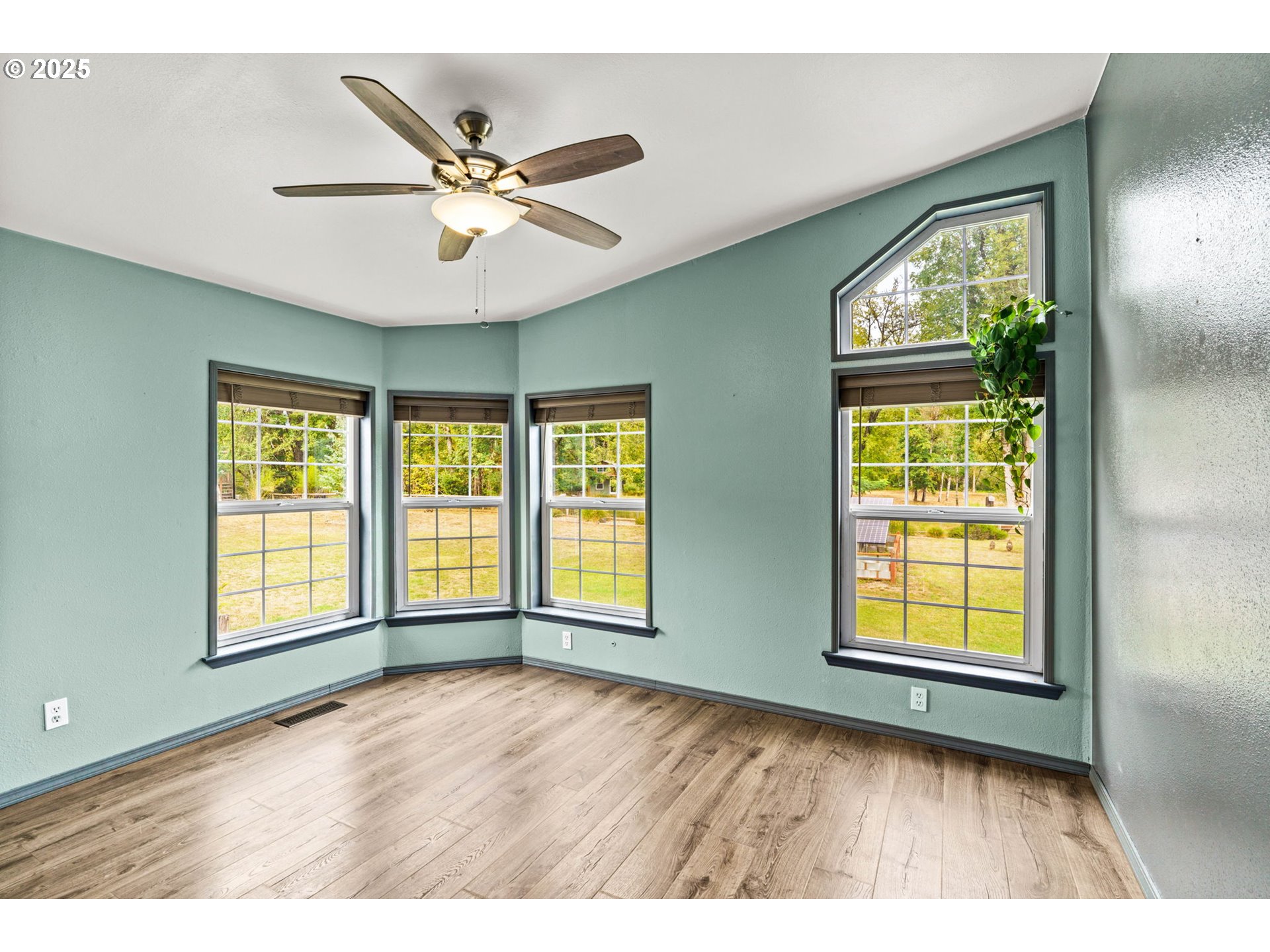 37495 Parsons Creek Road Springfield, OR 97478 - Photo 19 of 47 a view of an empty room with wooden floor and a window