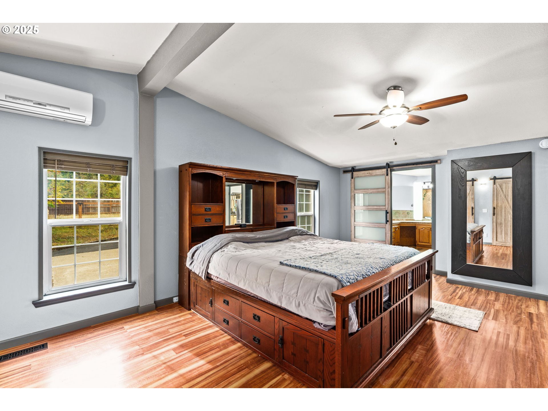 37495 Parsons Creek Road Springfield, OR 97478 - Photo 25 of 47 a bedroom with a large bed chandelier and a window