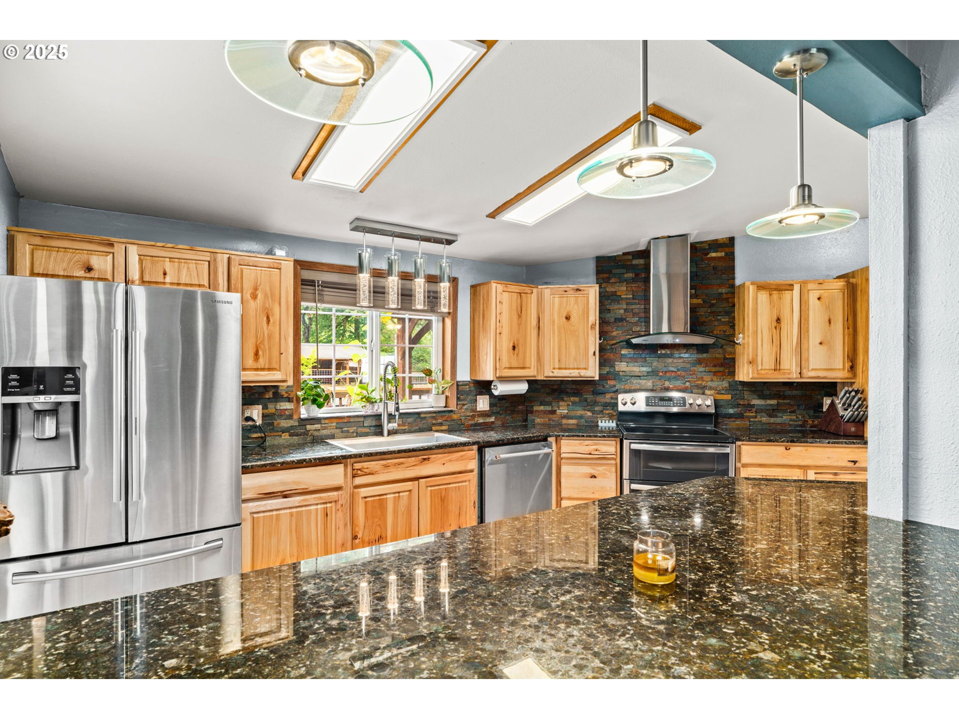37495 Parsons Creek Road Springfield, OR 97478 - Photo 10 of 47 a kitchen with stainless steel appliances kitchen island granite countertop a refrigerator and a sink