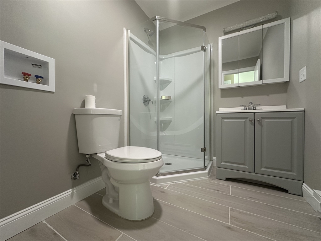 102 Wells Road Becket, MA 01223 - Photo 24 of 40 a white toilet sitting next to a bathroom sink