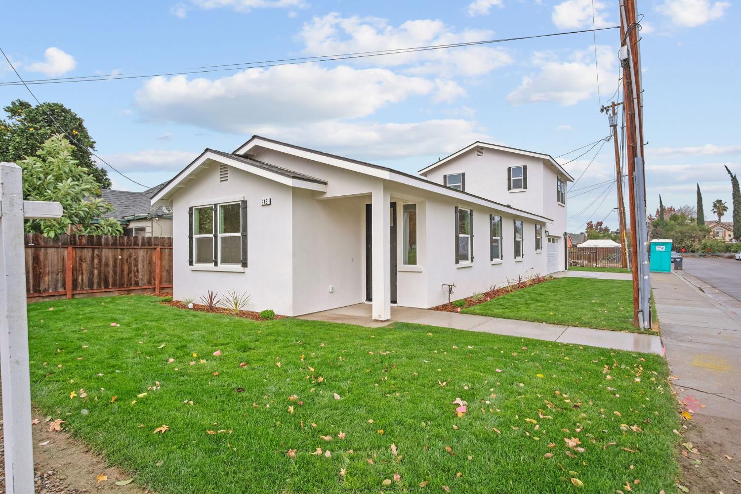 243 East E 3rd Street Tracy, CA 95376 - Photo 1 of 29 a front view of a house with a yard