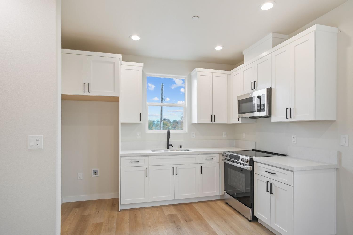 243 East E 3rd Street Tracy, CA 95376 - Photo 15 of 29 a kitchen with white cabinets and white appliances