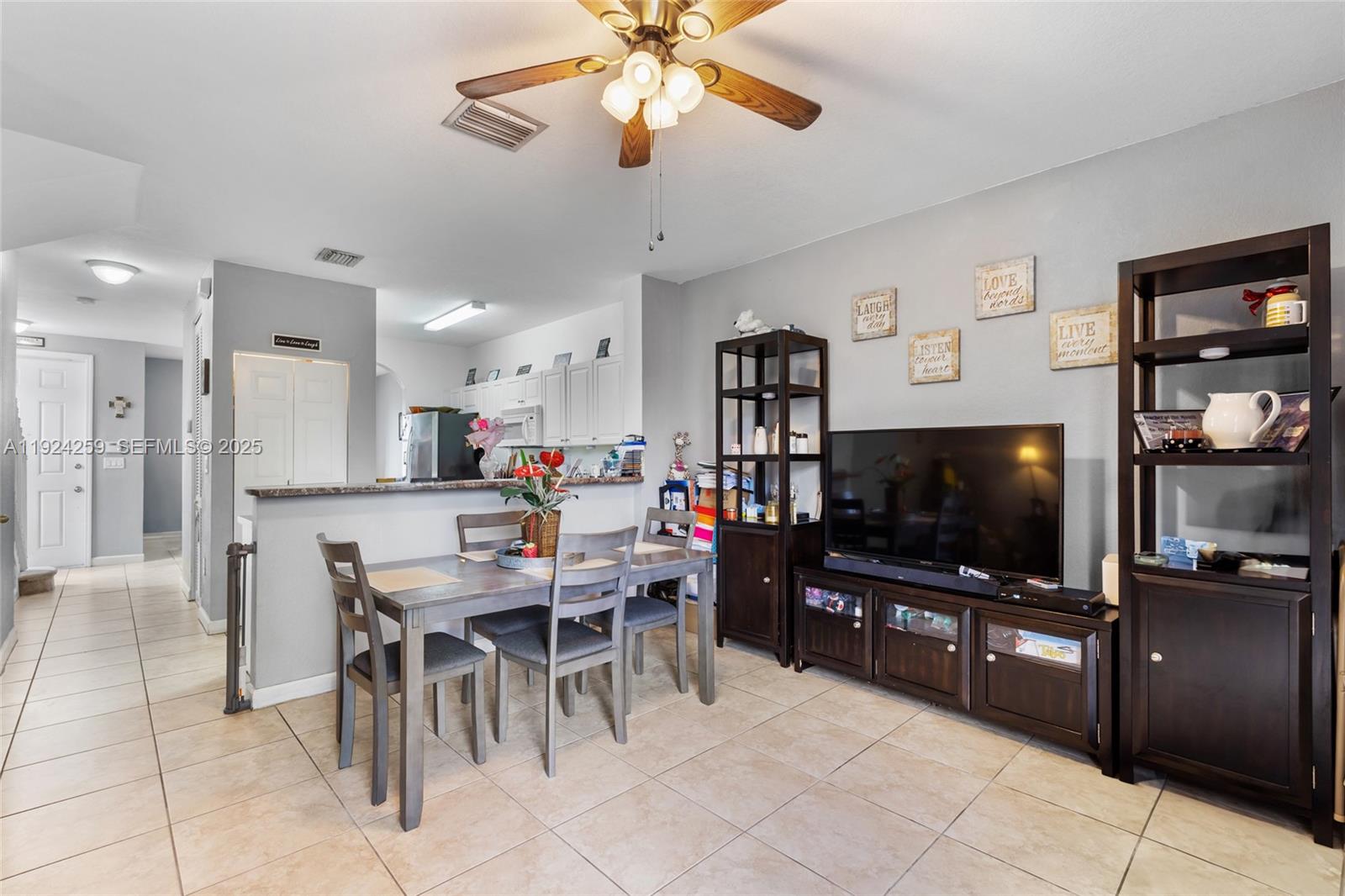 230 Southeast 29th Avenue, Unit 12 Homestead, FL 33033 - Photo 11 of 29 a dining room with furniture and window