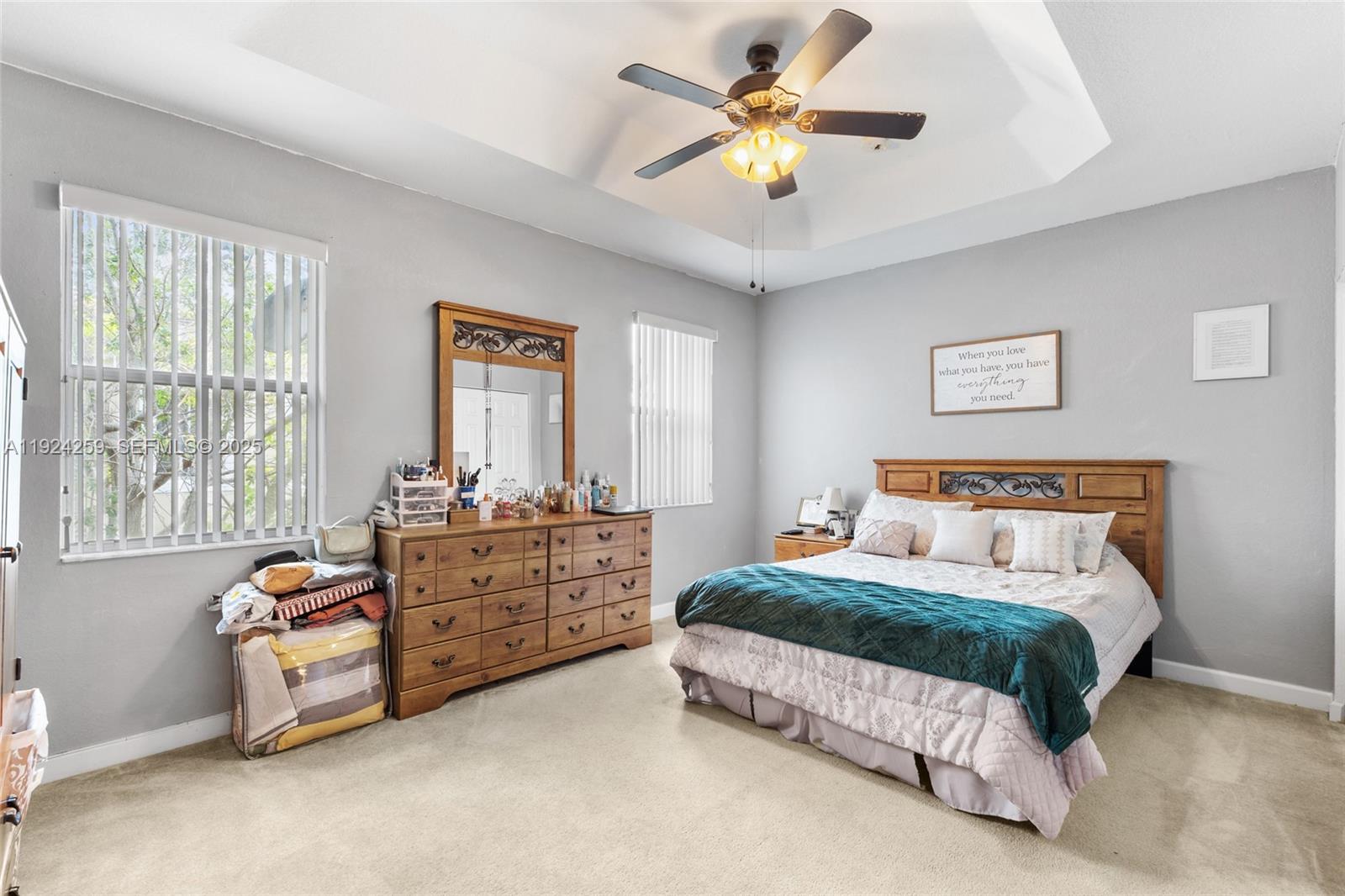 230 Southeast 29th Avenue, Unit 12 Homestead, FL 33033 - Photo 14 of 29 a bedroom with a bed and a chandelier