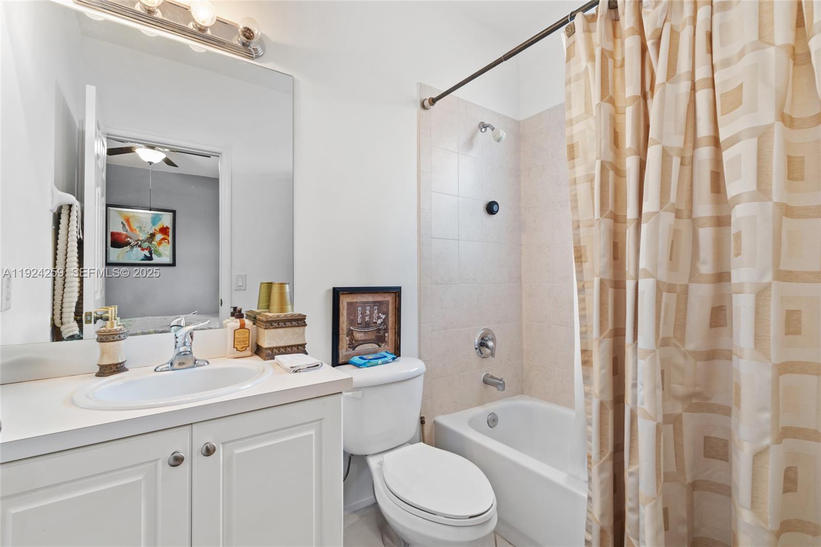 230 Southeast 29th Avenue, Unit 12 Homestead, FL 33033 - Photo 17 of 29 a bathroom with a sink a toilet a mirror a vanity and shower