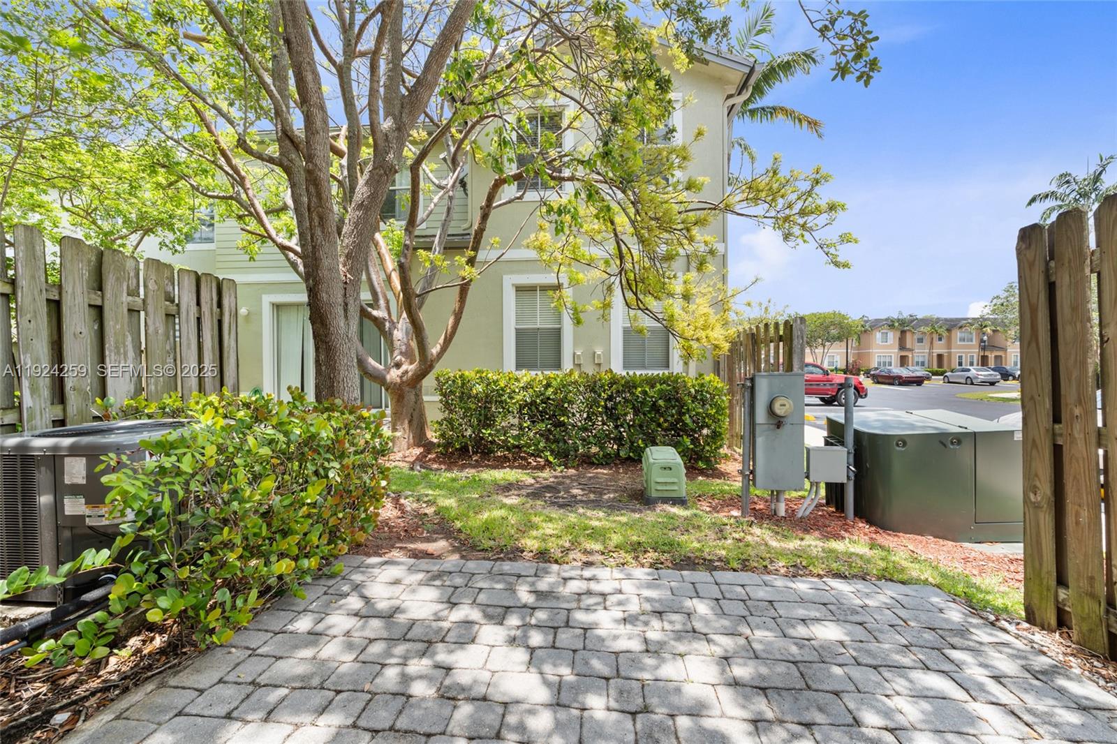 230 Southeast 29th Avenue, Unit 12 Homestead, FL 33033 - Photo 20 of 29 a front view of a house with a yard and potted plants