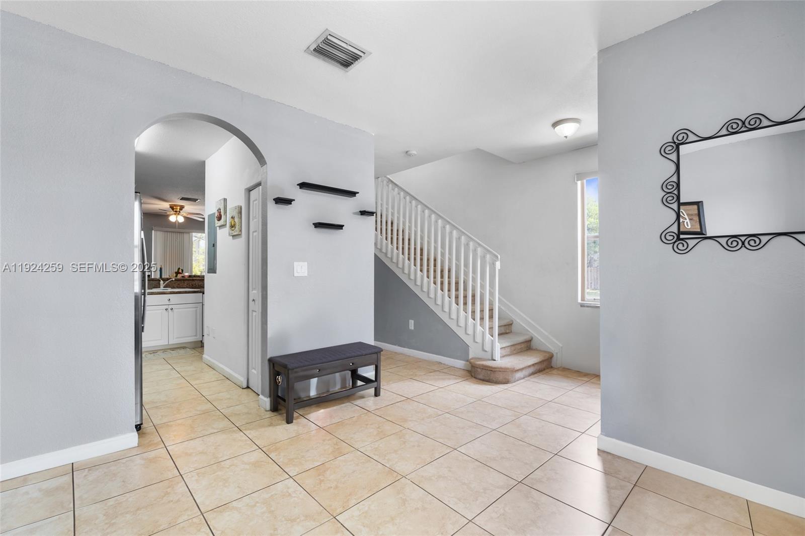 230 Southeast 29th Avenue, Unit 12 Homestead, FL 33033 - Photo 4 of 29 a view of a hallway with a living room and entryway