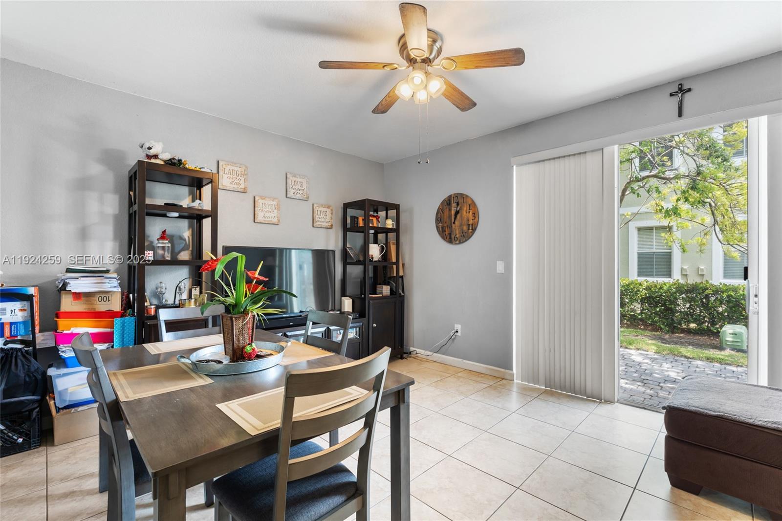 230 Southeast 29th Avenue, Unit 12 Homestead, FL 33033 - Photo 9 of 29 a dining room with furniture a window and a chandelier