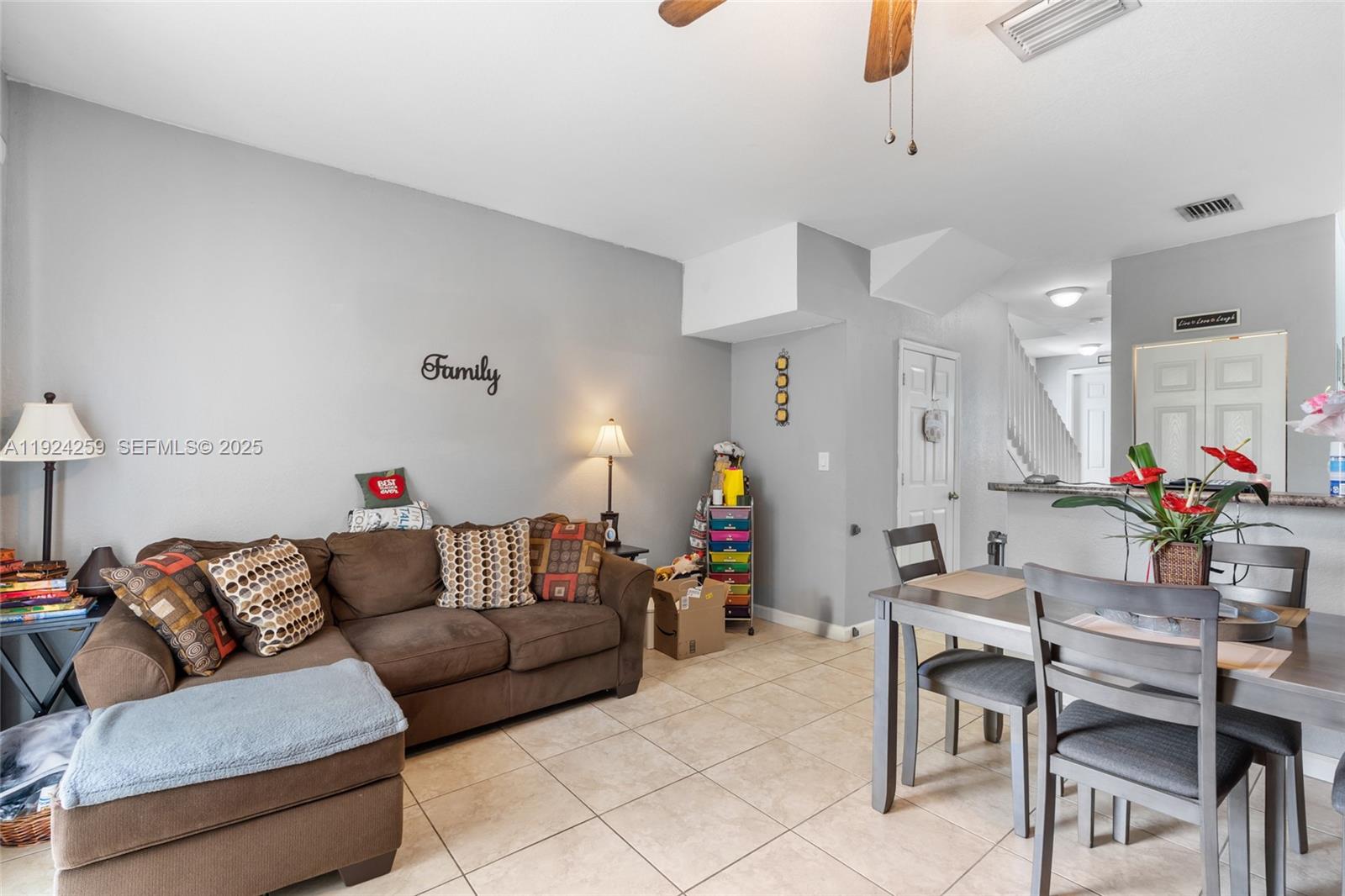 230 Southeast 29th Avenue, Unit 12 Homestead, FL 33033 - Photo 10 of 29 a living room with furniture and a chandelier