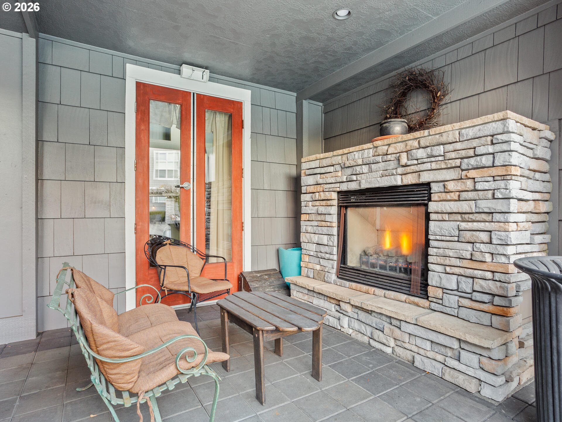 758 Southeast Fairwinds Loop Vancouver, WA 98661 - Photo 23 of 30 a living room with chairs a fireplace and a floor to ceiling window