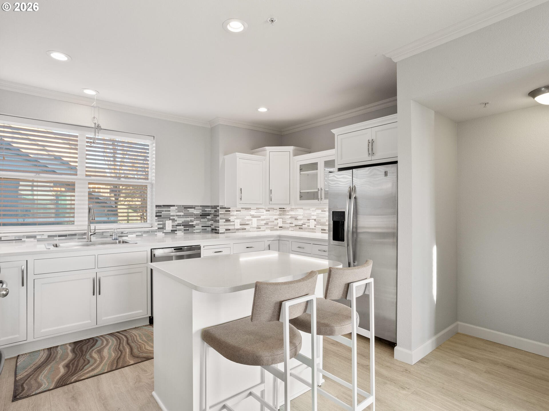 758 Southeast Fairwinds Loop Vancouver, WA 98661 - Photo 6 of 30 a kitchen with stainless steel appliances granite countertop a stove a sink a refrigerator and white cabinets with wooden floor