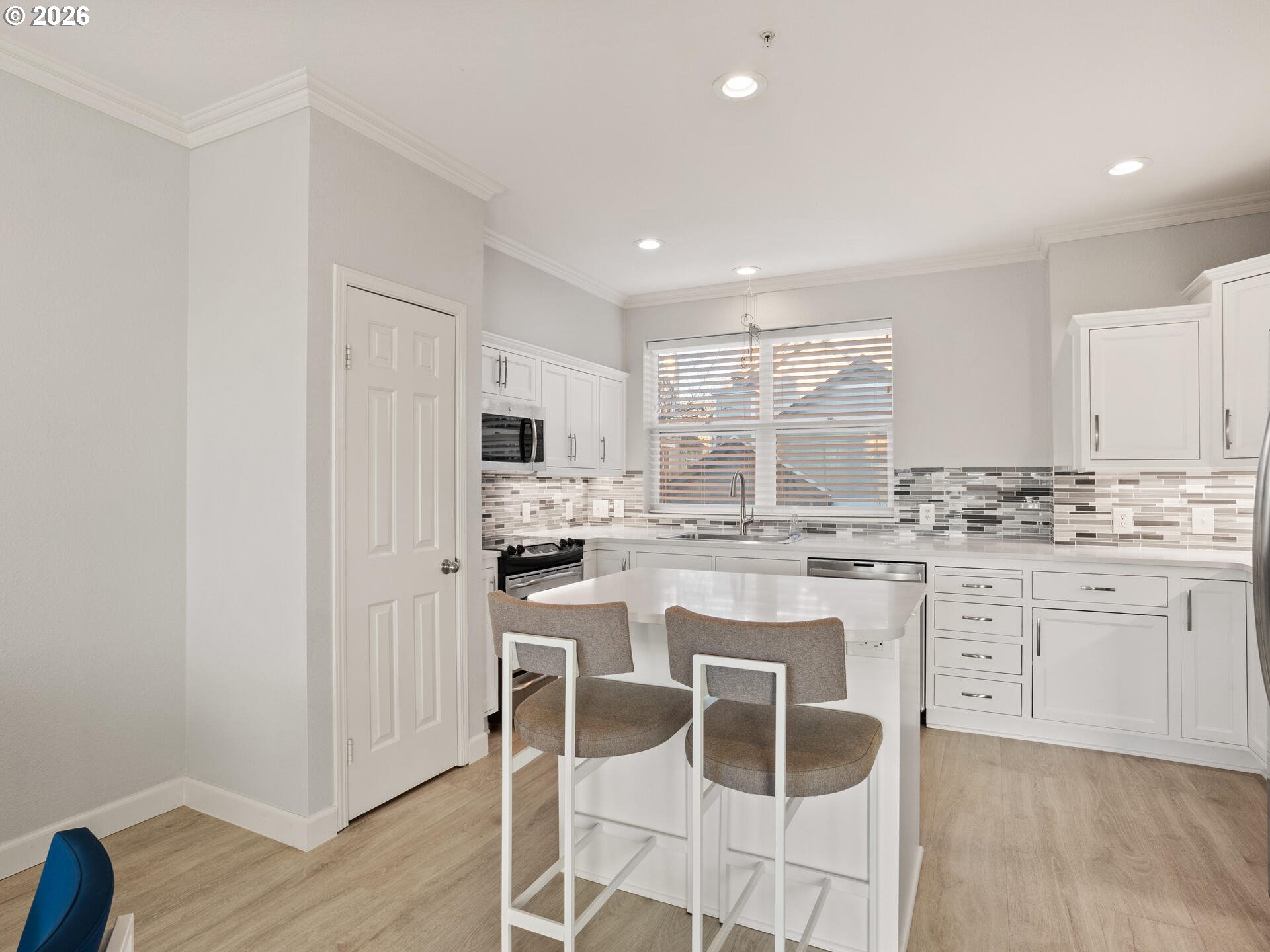 758 Southeast Fairwinds Loop Vancouver, WA 98661 - Photo 8 of 30 a kitchen with white cabinets and white appliances