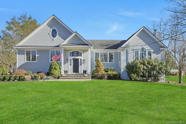 a front view of house with yard and green space