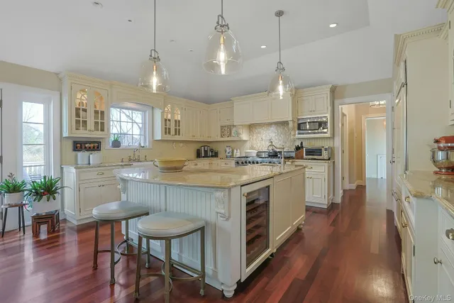 a kitchen with a stove a refrigerator a sink dishwasher with a dining table and chairs