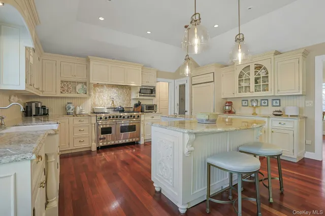 a kitchen with cabinets a sink a counter space stainless steel appliances and cabinets