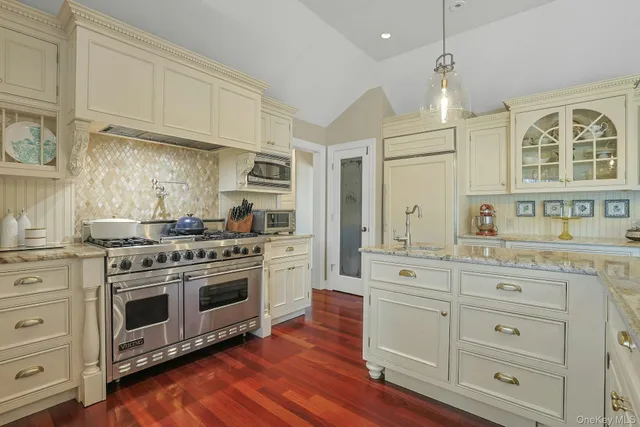 a kitchen with stainless steel appliances granite countertop a stove and a sink
