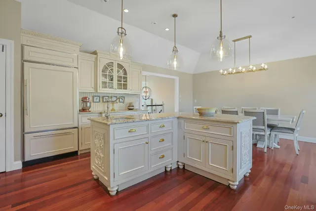 a kitchen with a white cabinets sink and wooden floor