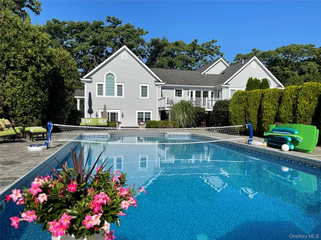 a view of a pool a fire pit and outdoor kitchen