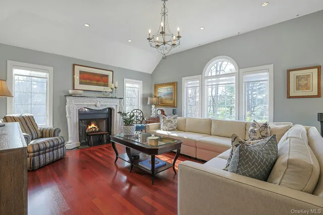 a living room with furniture fireplace and a large window