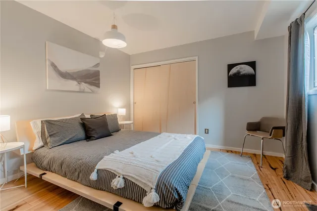 a bedroom with a bed and a chair