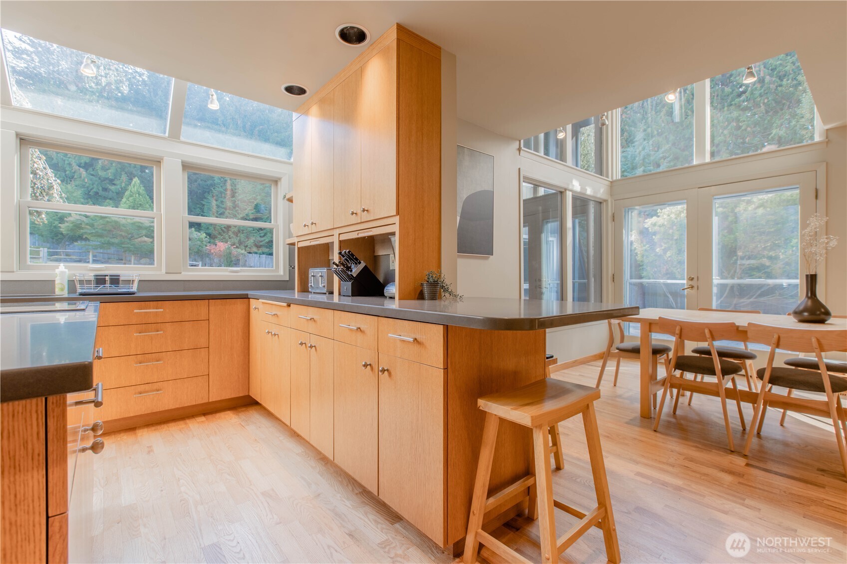 123 Hiline Road Bellingham, WA 98229 - Photo 3 of 40 a kitchen with stainless steel appliances wooden floors and white cabinets