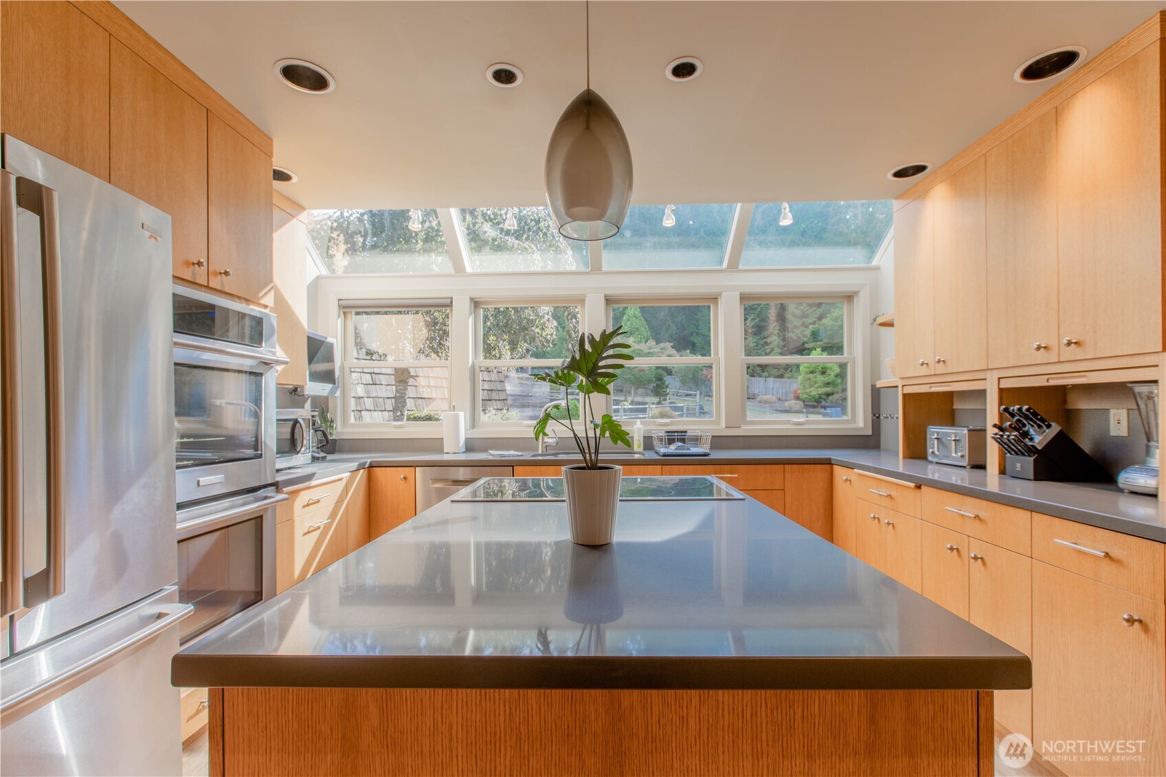 123 Hiline Road Bellingham, WA 98229 - Photo 4 of 40 a view of a kitchen with kitchen island a large window a sink and stainless steel appliances