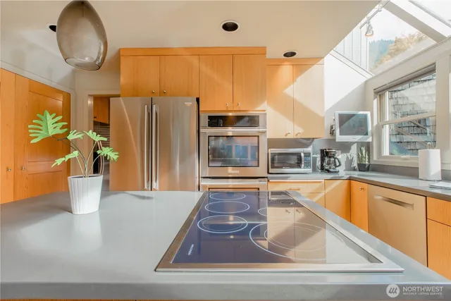 a view of a kitchen with a tub and wooden floor