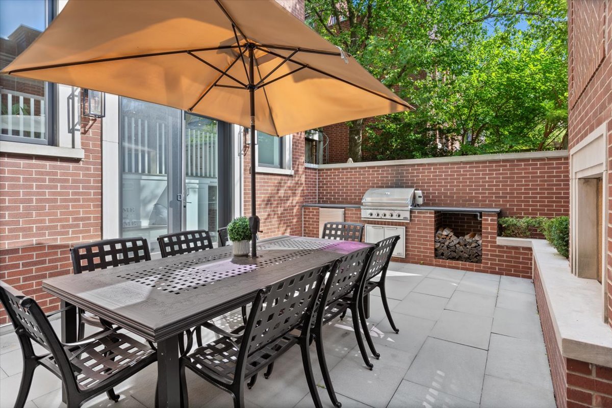 2138 North Seminary Avenue Chicago, IL 60614 - Photo 67 of 76 a view of a patio with a table and chairs under an umbrella