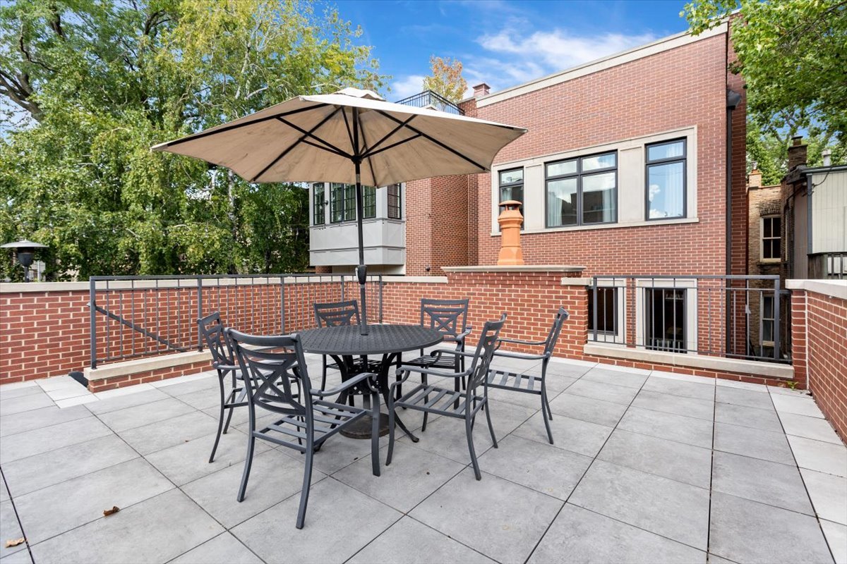 2138 North Seminary Avenue Chicago, IL 60614 - Photo 69 of 76 a view of a patio with a table and chairs under an umbrella