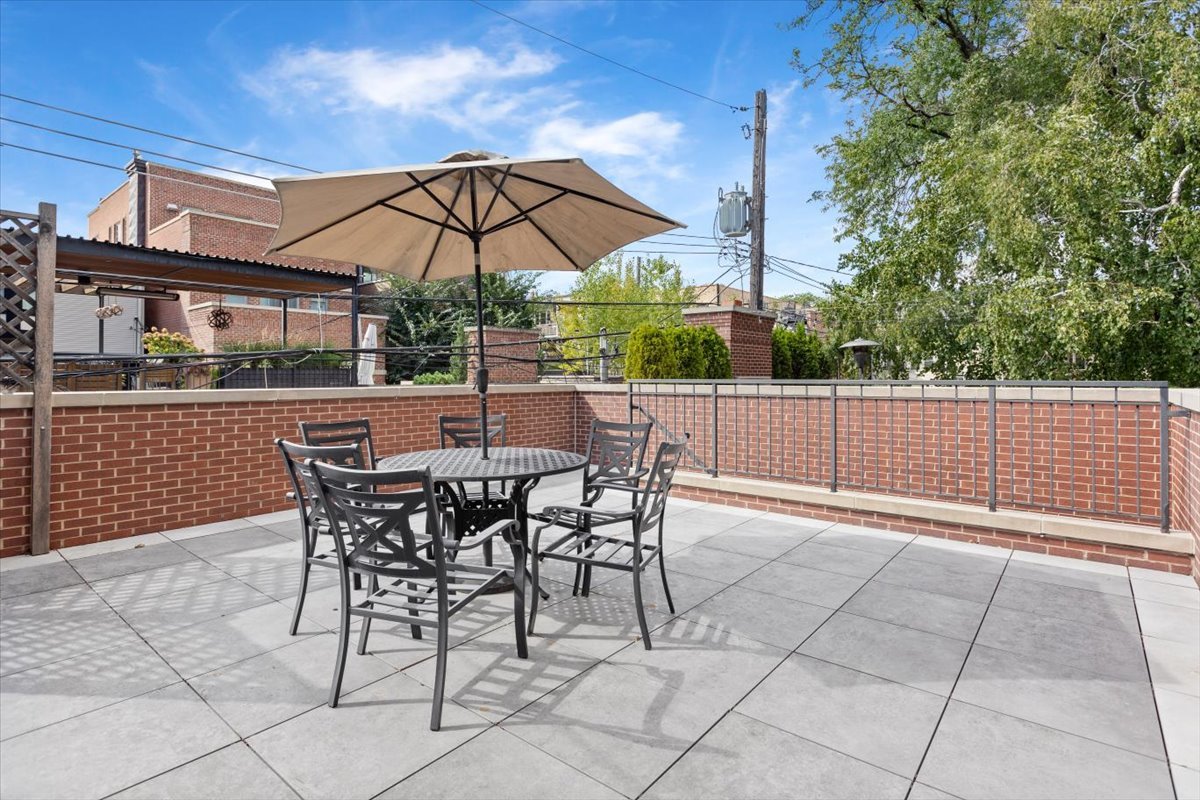 2138 North Seminary Avenue Chicago, IL 60614 - Photo 70 of 76 a view of a patio with table and chairs under an umbrella