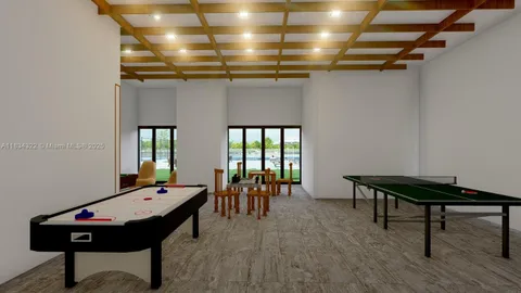 a room with furniture pool table and windows